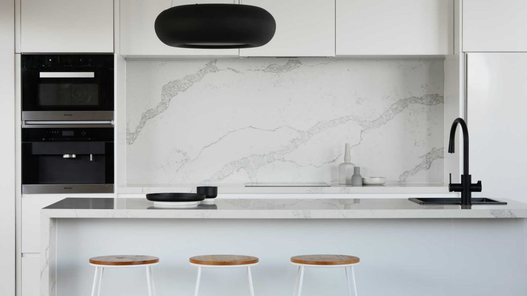 Modern kitchen design idea with marble splashback and black accents