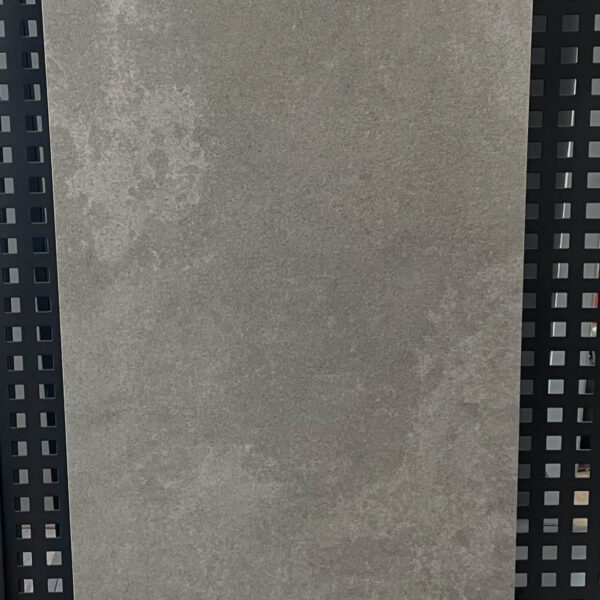 Gray tile sample labeled D126002 on display.