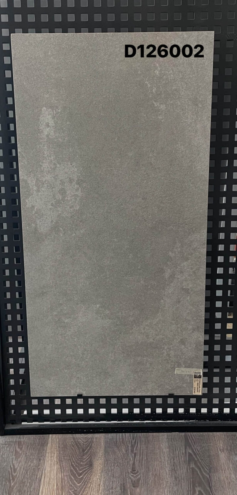 Gray tile sample labeled D126002 on display.