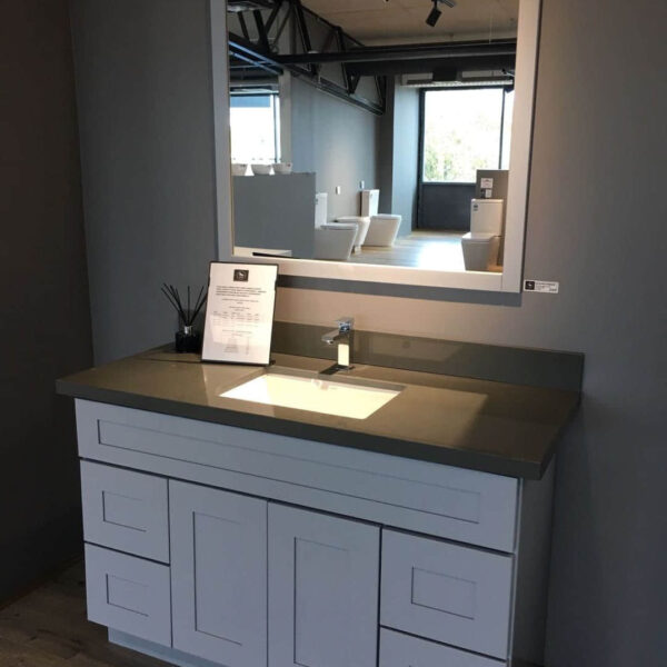 Modern bathroom vanity with single basin and large mirror.