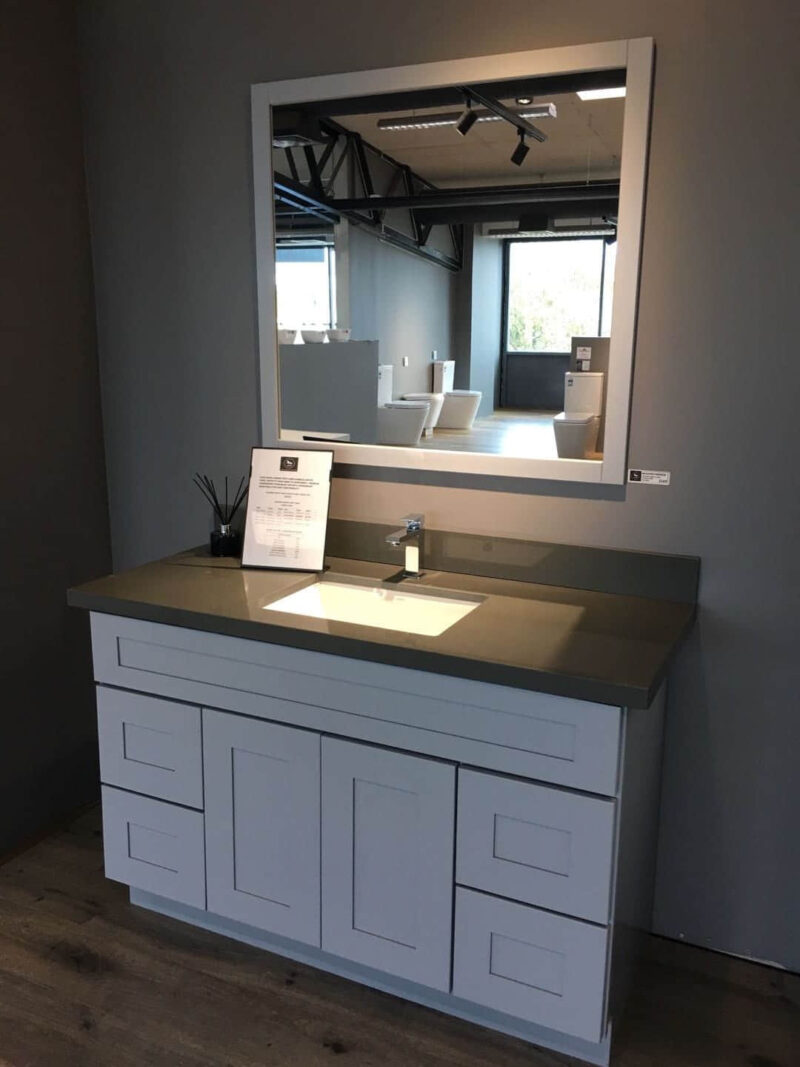 Modern bathroom vanity with single basin and large mirror.