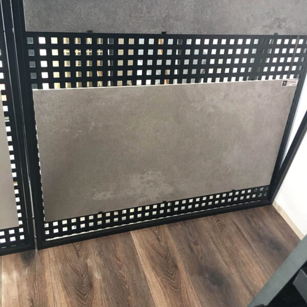 Tile display on wooden floor in showroom.