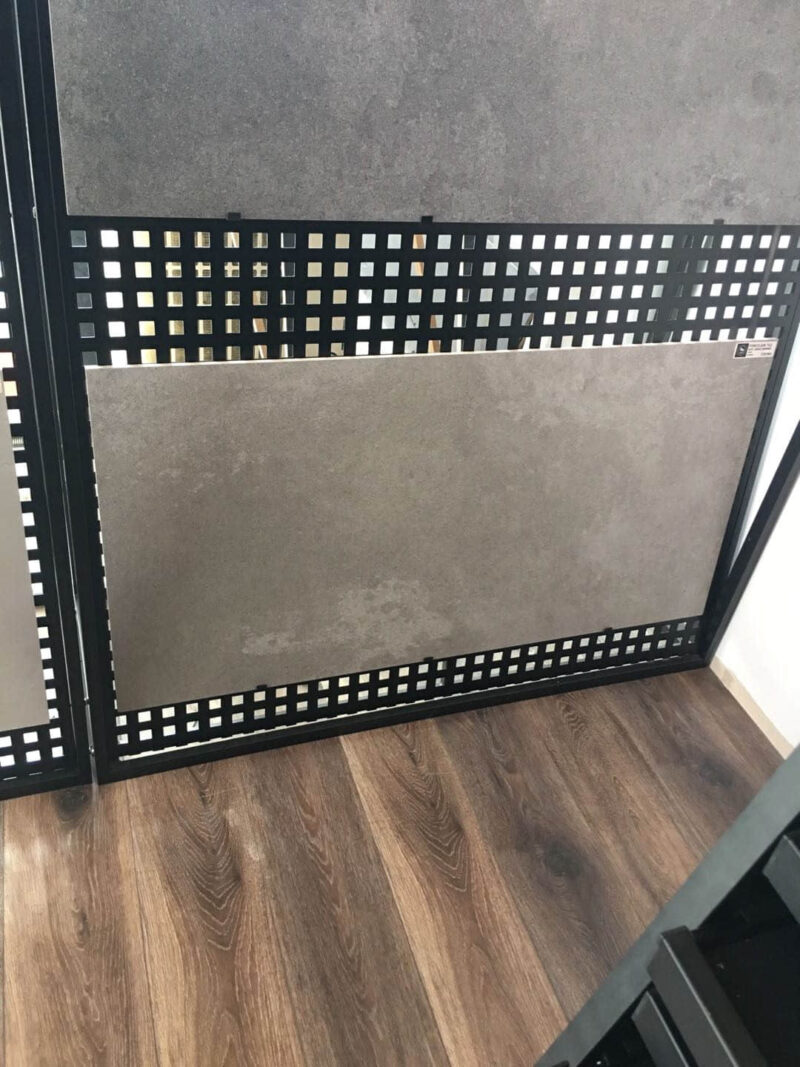 Tile display on wooden floor in showroom.