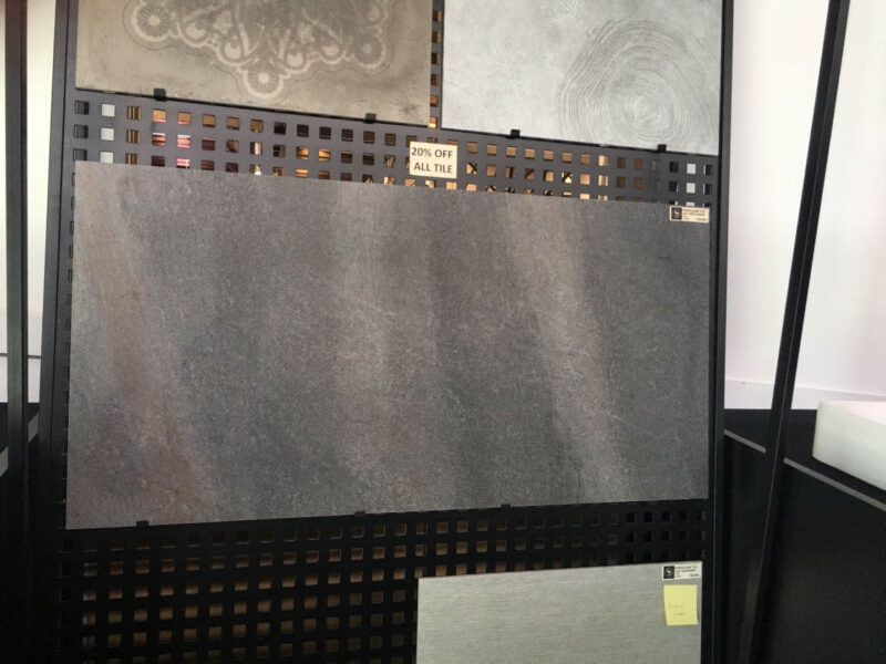 Display of various tiles with a 20% off sign.