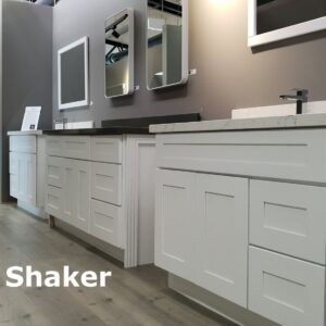 White Shaker kitchen cabinets displayed in a showroom.