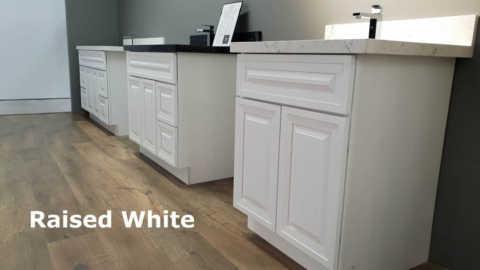 White raised kitchen cabinets on wooden floor.