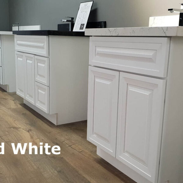 White raised kitchen cabinets on wooden floor.