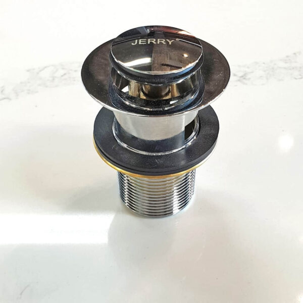 Chrome sink drain plug on white surface.