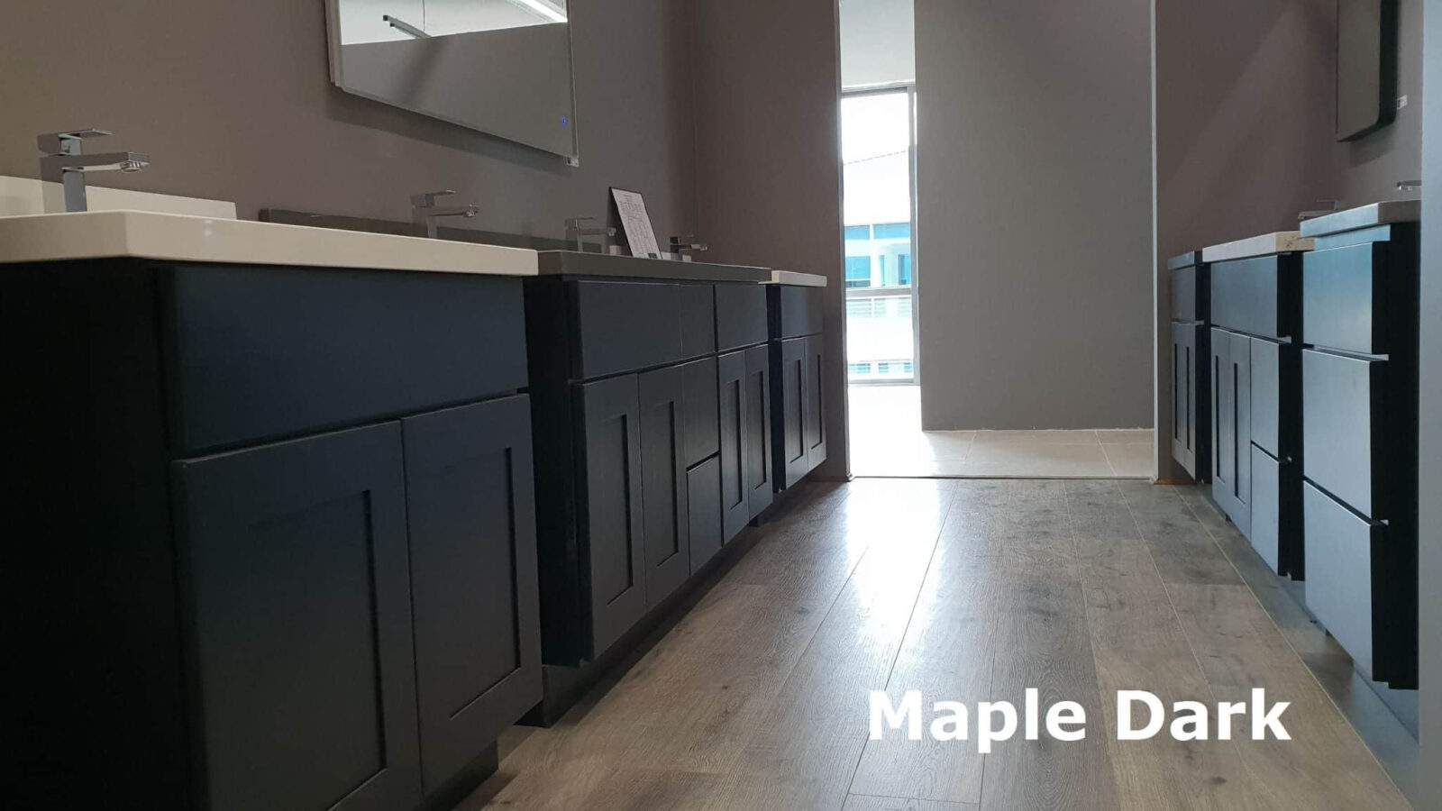 Dark maple kitchen cabinets with modern sinks and mirrors.