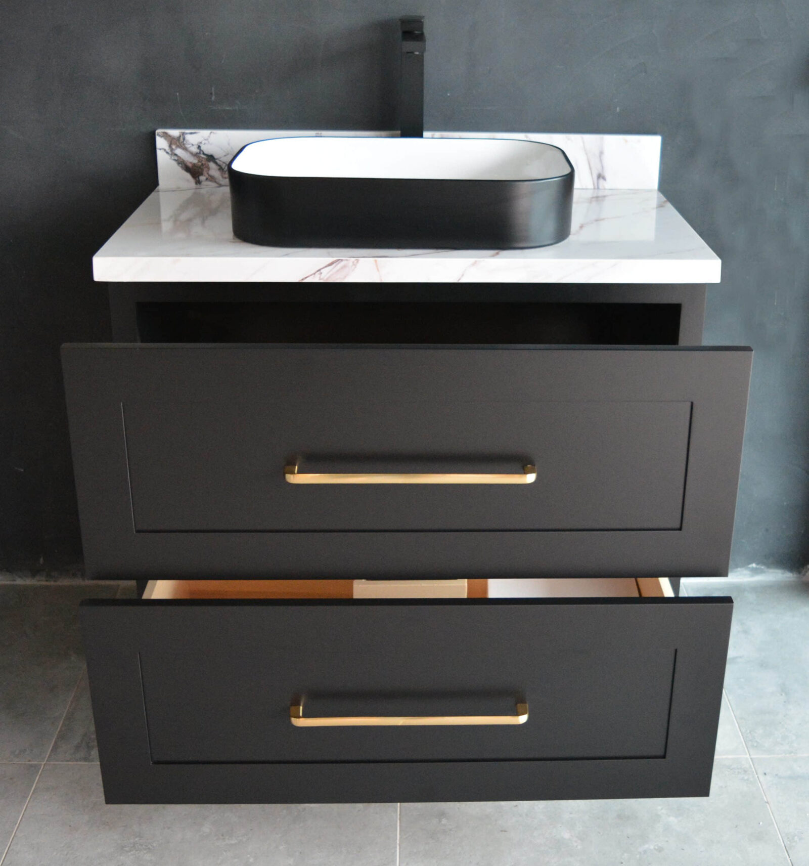 Black freestanding vanity with open drawers and modern sink.