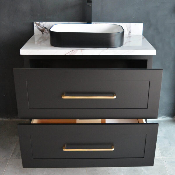 Black freestanding vanity with open drawers and modern sink.