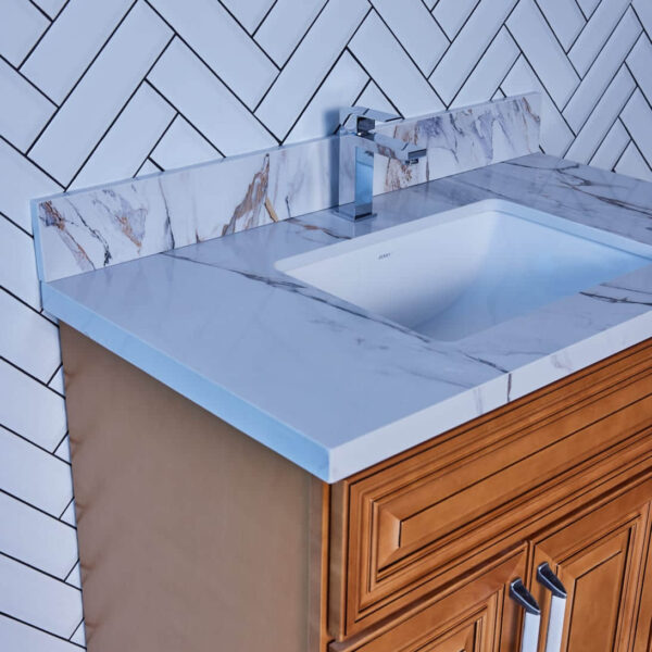 Marble countertop with sink and wooden cabinet.