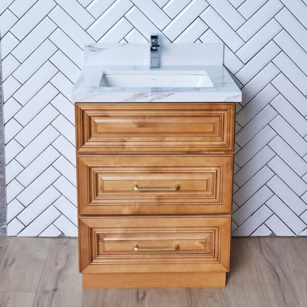 COG-VDB2420-32.5-1.jpg Wooden bathroom vanity with white sink and herringbone tile background.