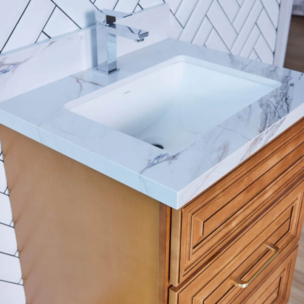 Wooden bathroom vanity with marble countertop and modern faucet.