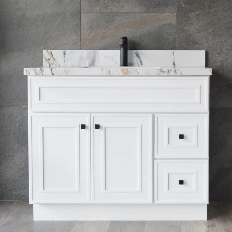White bathroom vanity with marble countertop and black faucet.