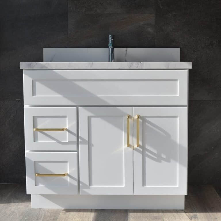 White bathroom vanity with gold handles and marble countertop.
