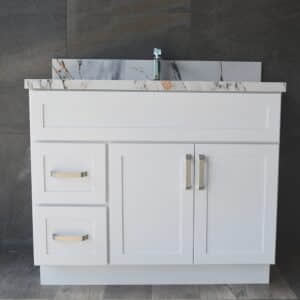 White bathroom vanity with marble countertop and modern faucet.