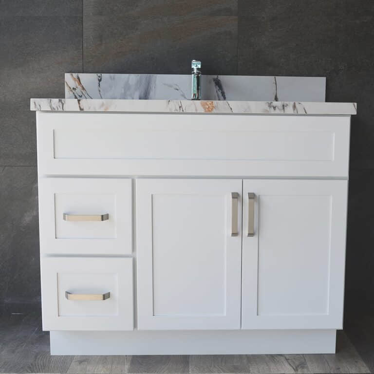 White bathroom vanity with marble countertop and modern faucet.
