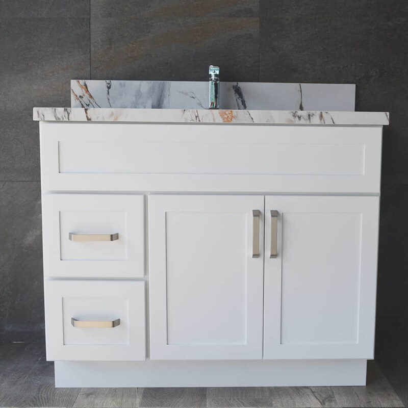 White bathroom vanity with marble countertop and modern faucet.