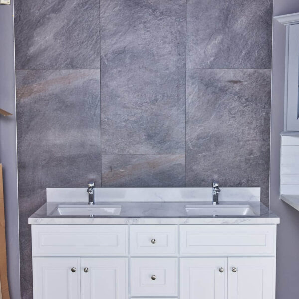 Double sink vanity with gray stone backsplash in modern bathroom.