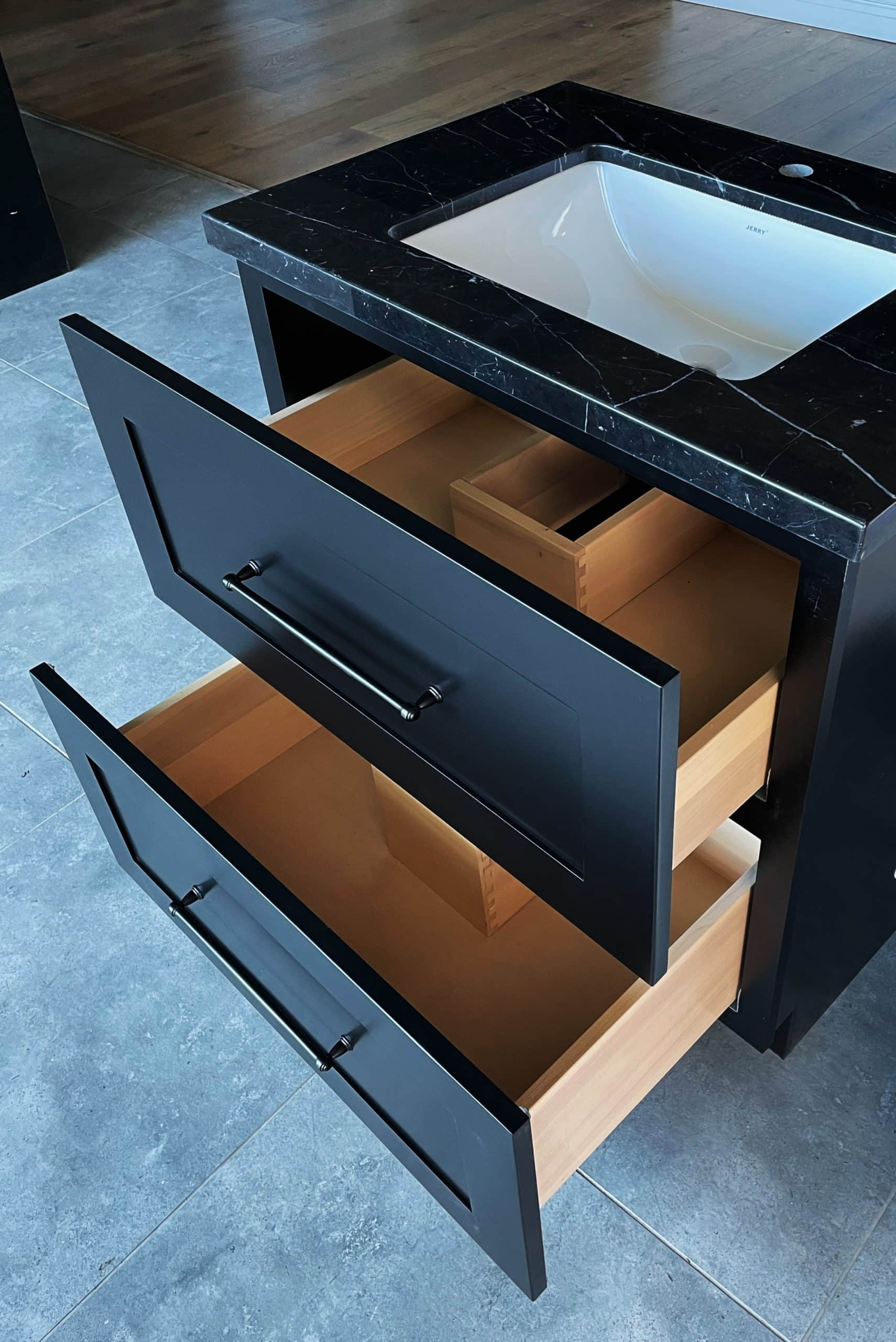 Black freestanding vanity with drawers and marble top, 800mm.
