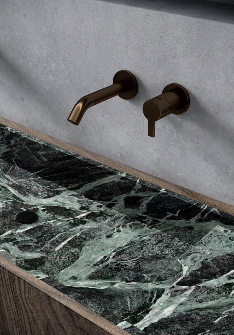 Emerald green sintered stone bench with bronze faucet.