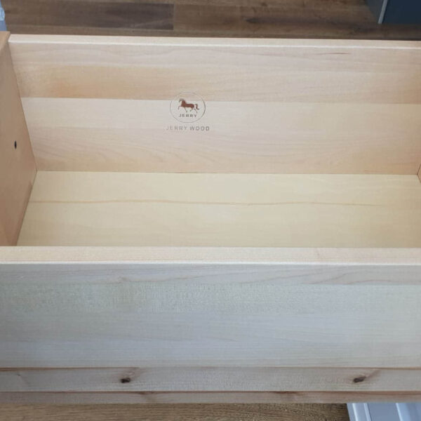 Open wooden kitchen drawer with dovetail joints.
