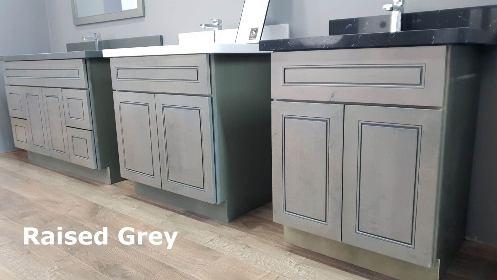 Grey kitchen cabinets with modern design and wooden floor.