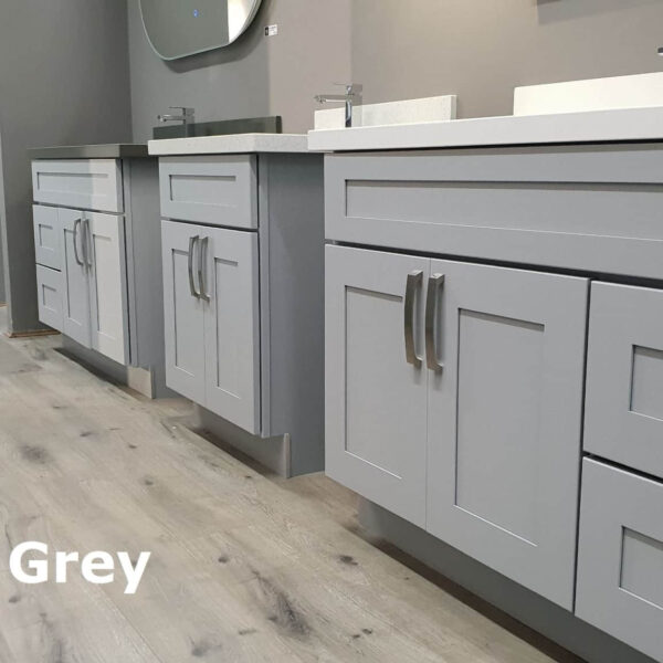 Maple Grey kitchen cabinets in a showroom with light wood flooring.