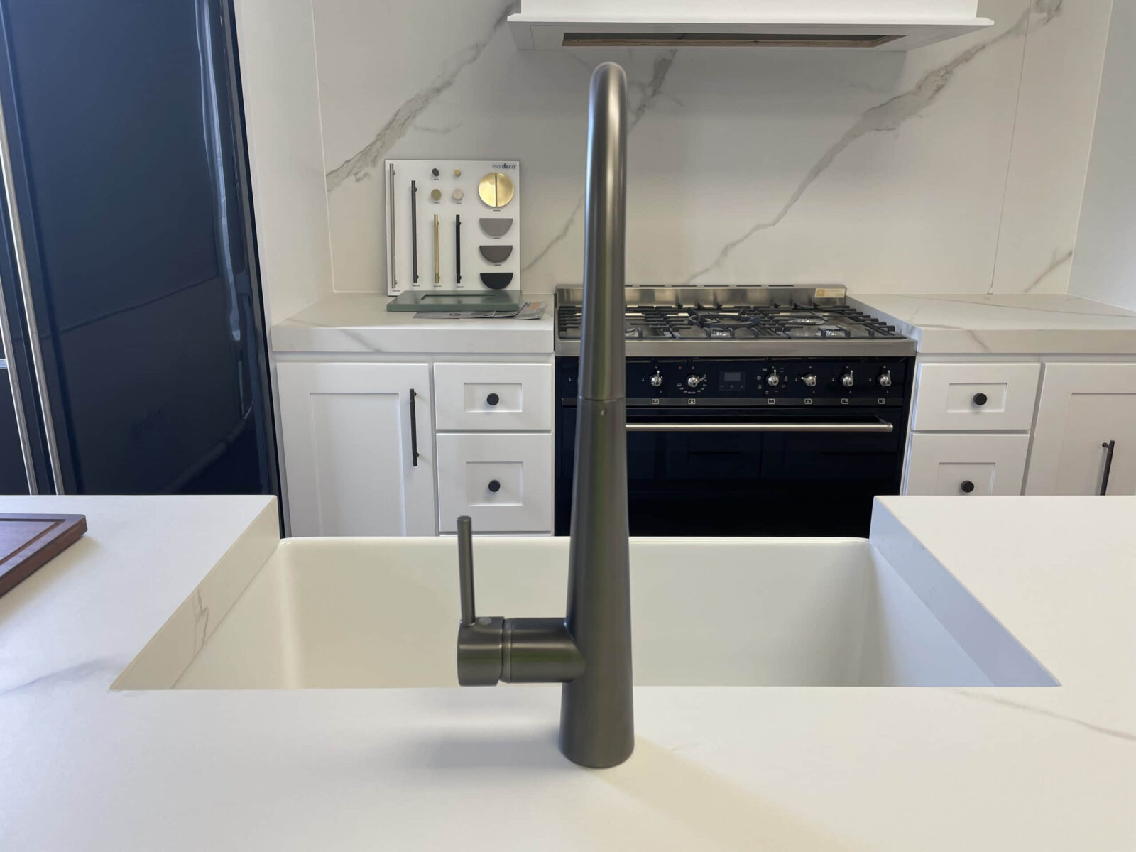 Modern kitchen with sleek faucet and marble backsplash.