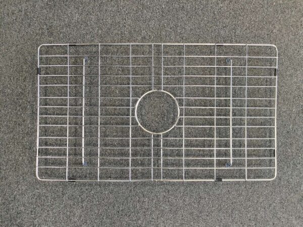 Metal sink protector on a gray surface.