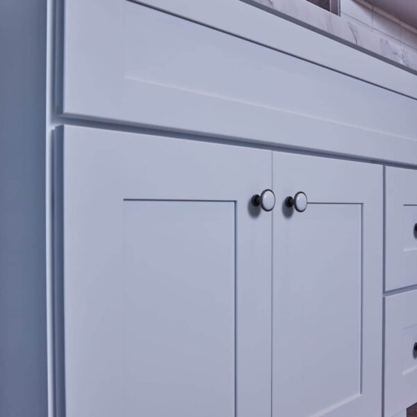 White kitchen cabinet with modern handles.