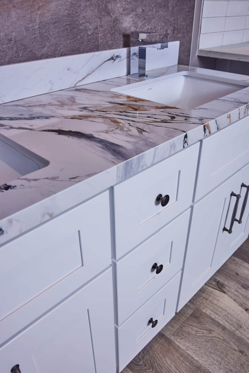 Marble countertop with white cabinets in a modern kitchen.