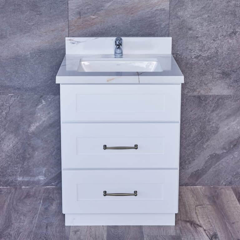 White bathroom vanity with three drawers and a marble countertop.