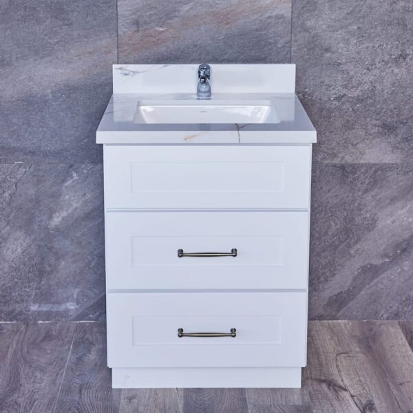 White bathroom vanity with three drawers and a marble countertop.