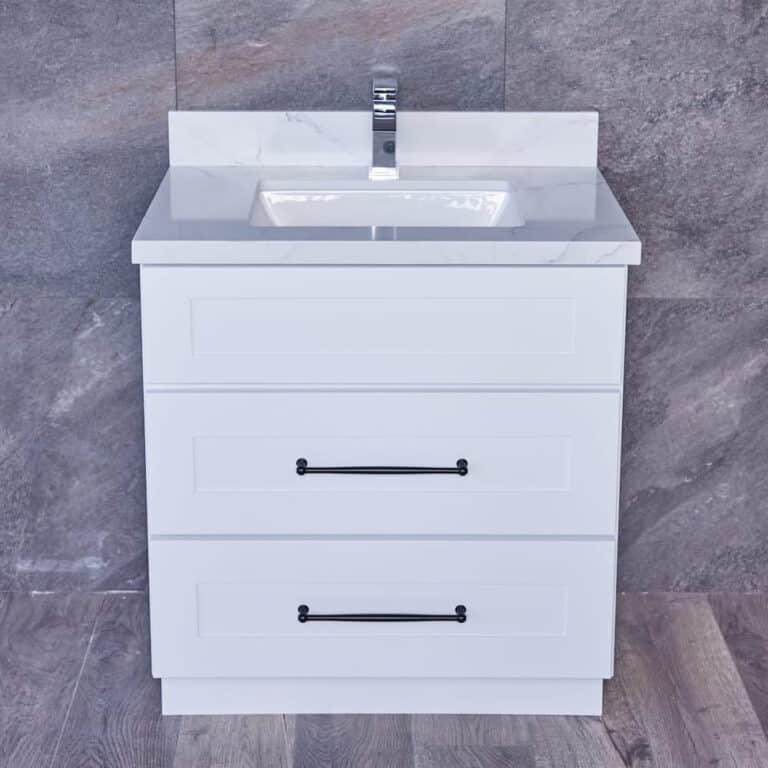 White bathroom vanity with marble countertop and modern faucet.
