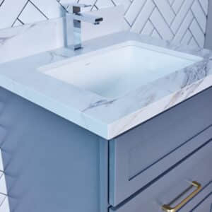 Modern bathroom vanity with marble countertop and herringbone tile backsplash.