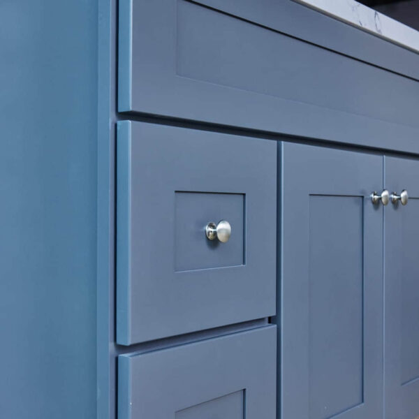 Blue kitchen cabinet with silver knobs.