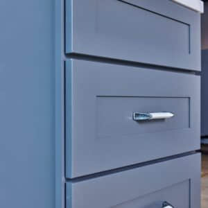 Blue kitchen cabinet with silver handle.