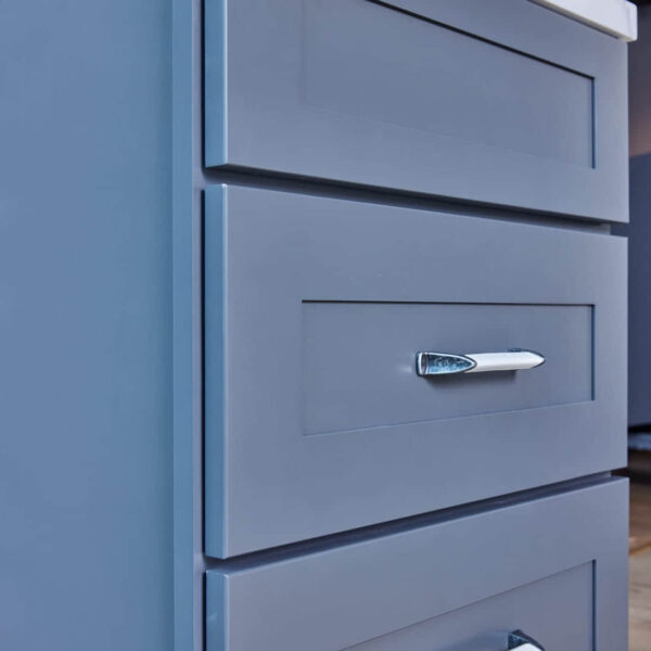 Blue kitchen cabinet with silver handle.