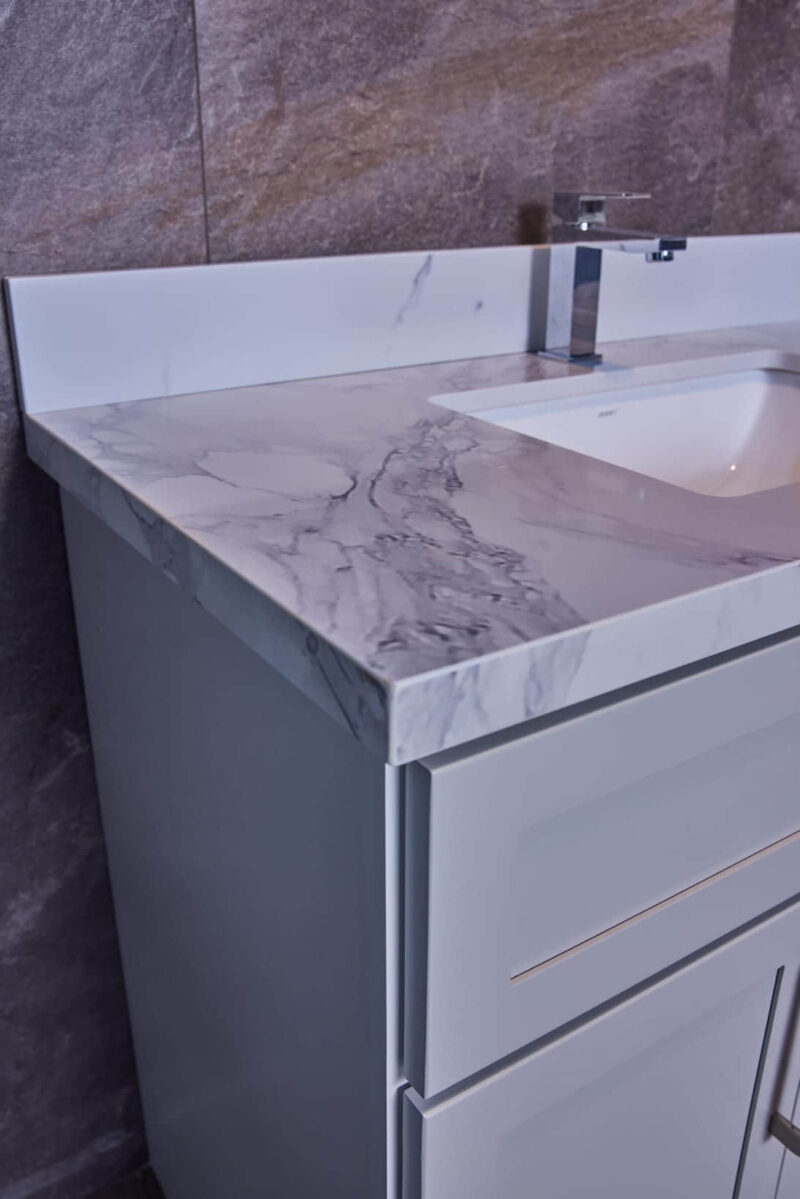 Marble countertop with integrated sink and modern faucet.