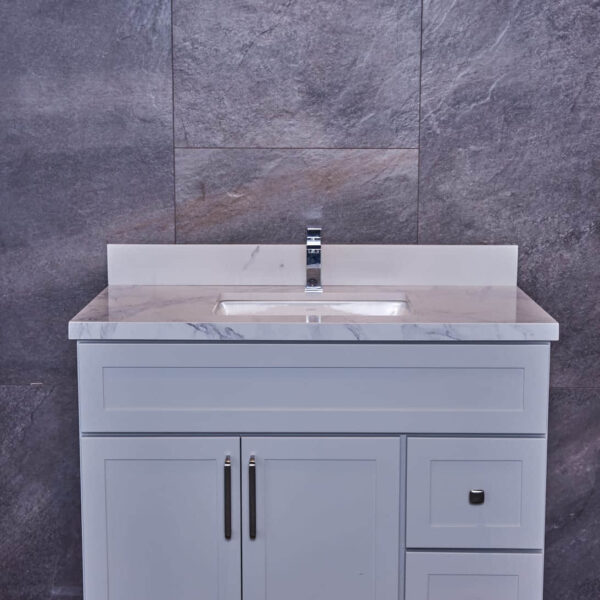 Modern bathroom vanity with marble countertop and gray tile backsplash.