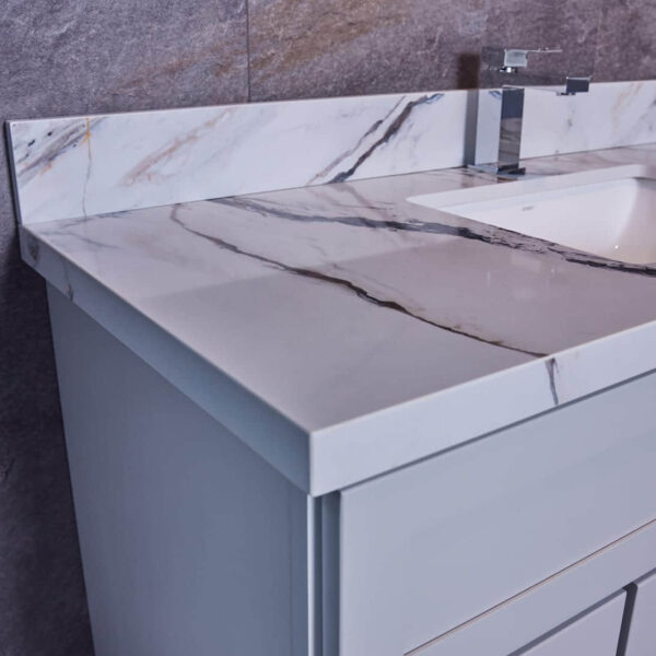 Marble bathroom vanity with modern faucet and backsplash.