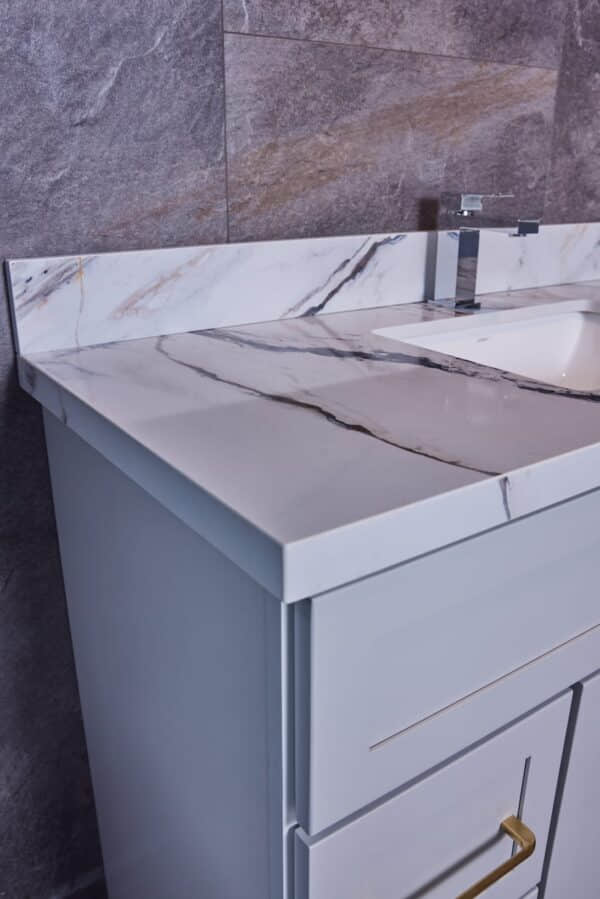 Marble bathroom vanity with modern faucet and backsplash.