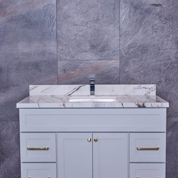 Modern bathroom vanity with marble countertop and gray cabinets.