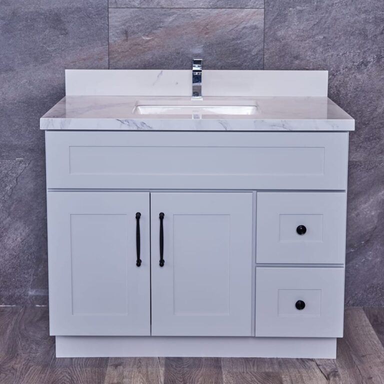 White bathroom vanity with marble countertop and modern faucet.