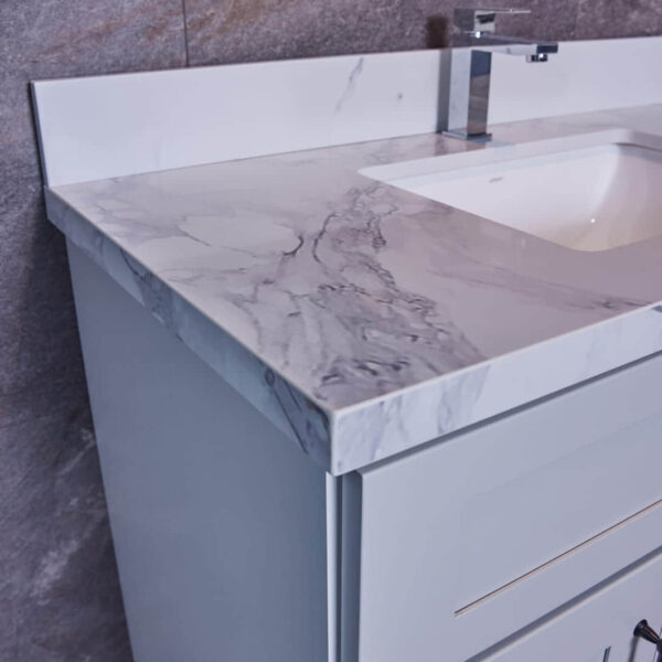 Modern bathroom vanity with marble countertop and sleek faucet.