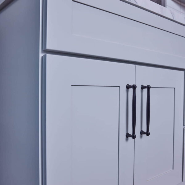 Modern kitchen cabinet with marble countertop and sleek handles.