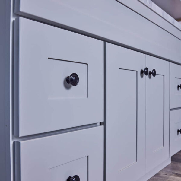 White kitchen cabinets with black knobs.