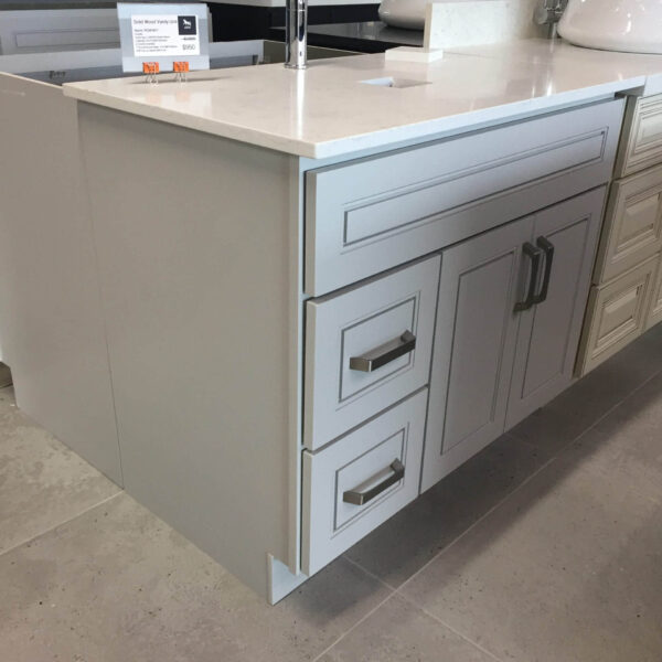 Modern kitchen island with white cabinets and sleek countertop.